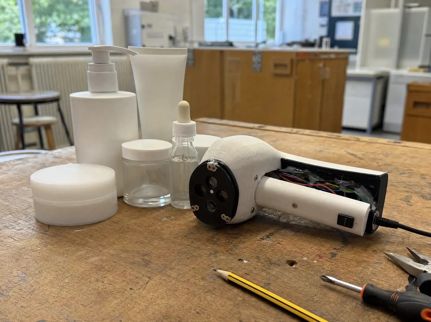 Saanvi, with DERMX. Plain unlabelled cosmetic bottles beside a small handheld skin-scanner device on a school bench