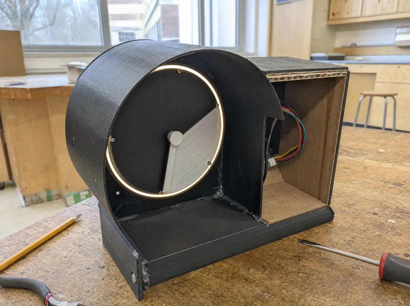 Meera, with Reboot team. A study focus pod with a glowing ring timer beside a wooden phone box
